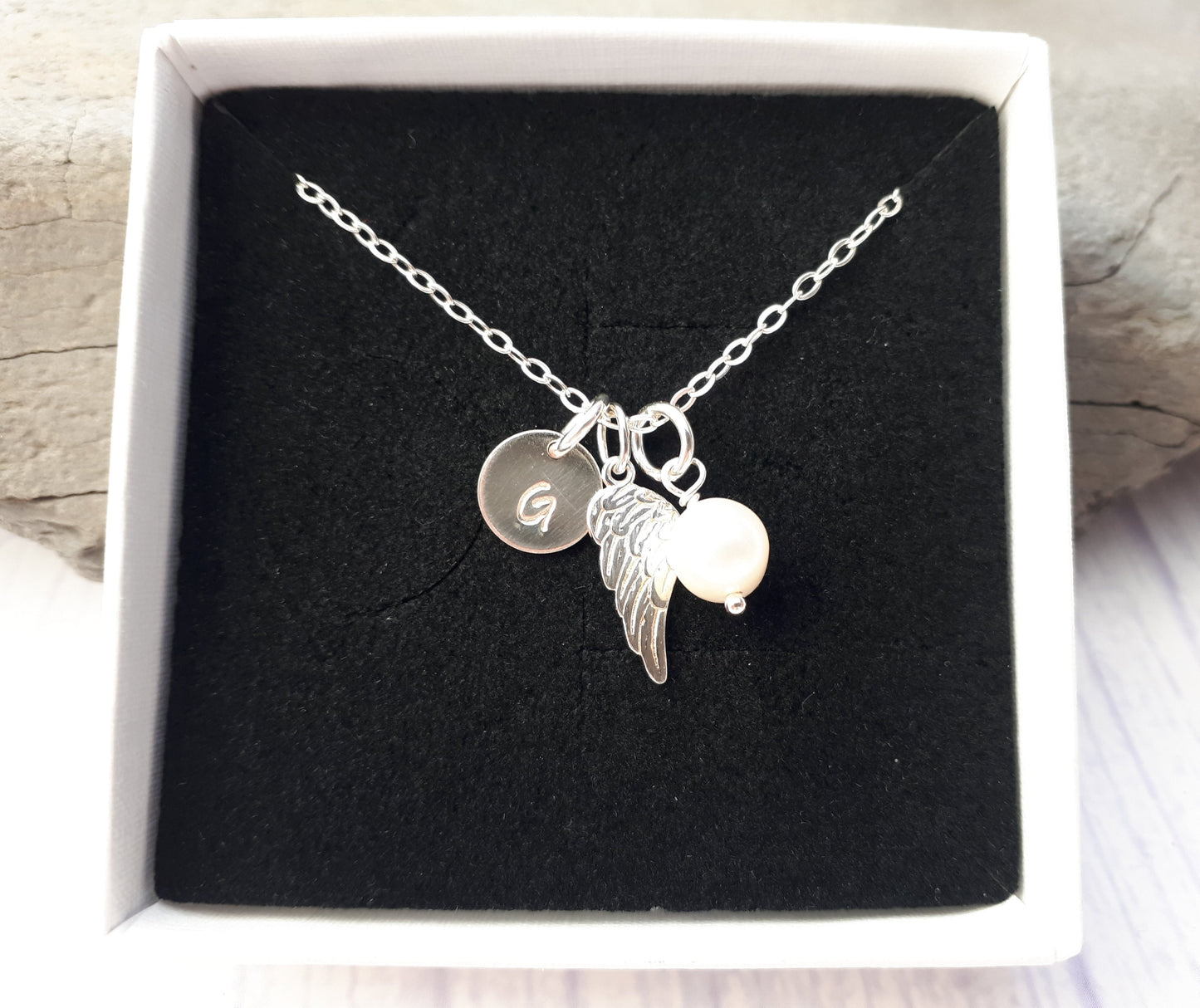 Angel wing necklace with freshwater pearl and initial.