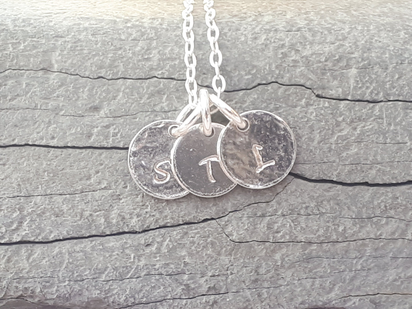 Family initial necklace in sterling silver.