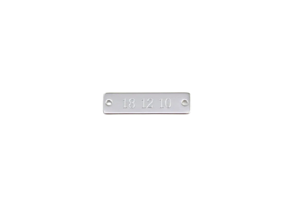 Engraved sterling silver rectangular tag.