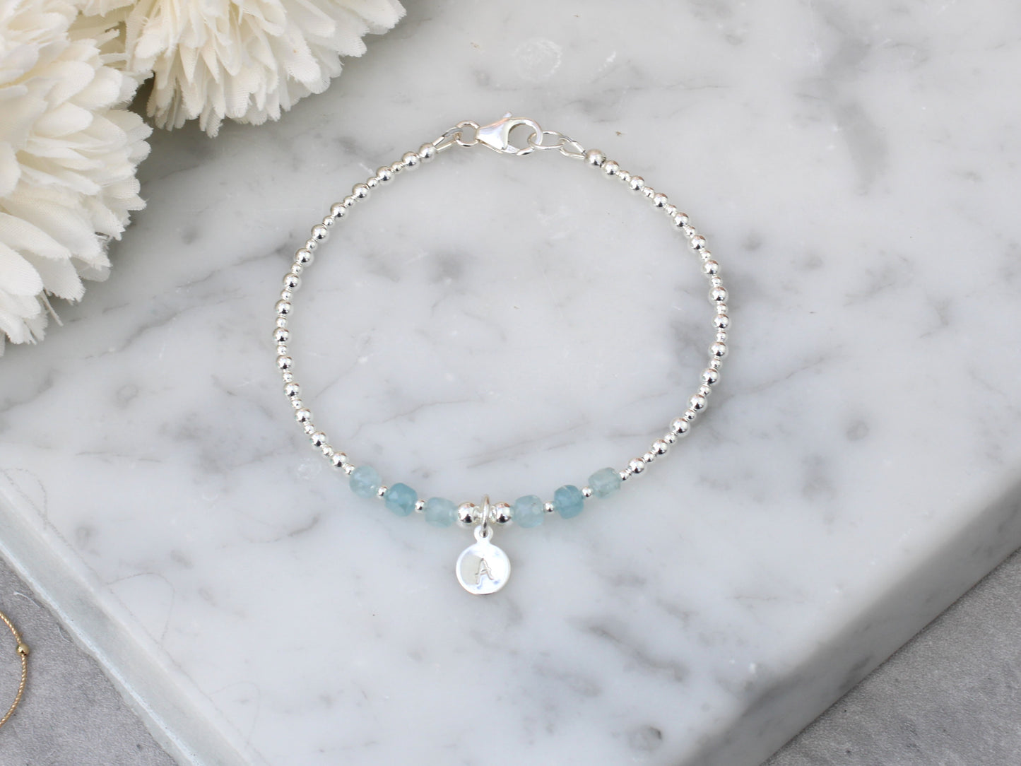 Aquamarine initial gemstone bracelet in silver.