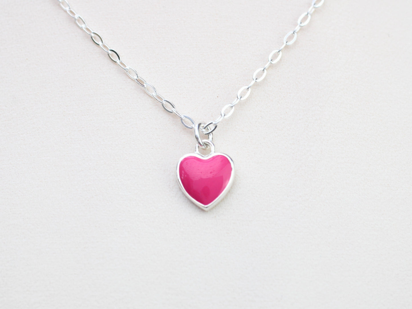 Pink heart charm necklace.