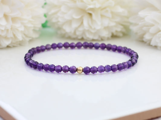 Amethyst bead bracelet with gold accent bead.