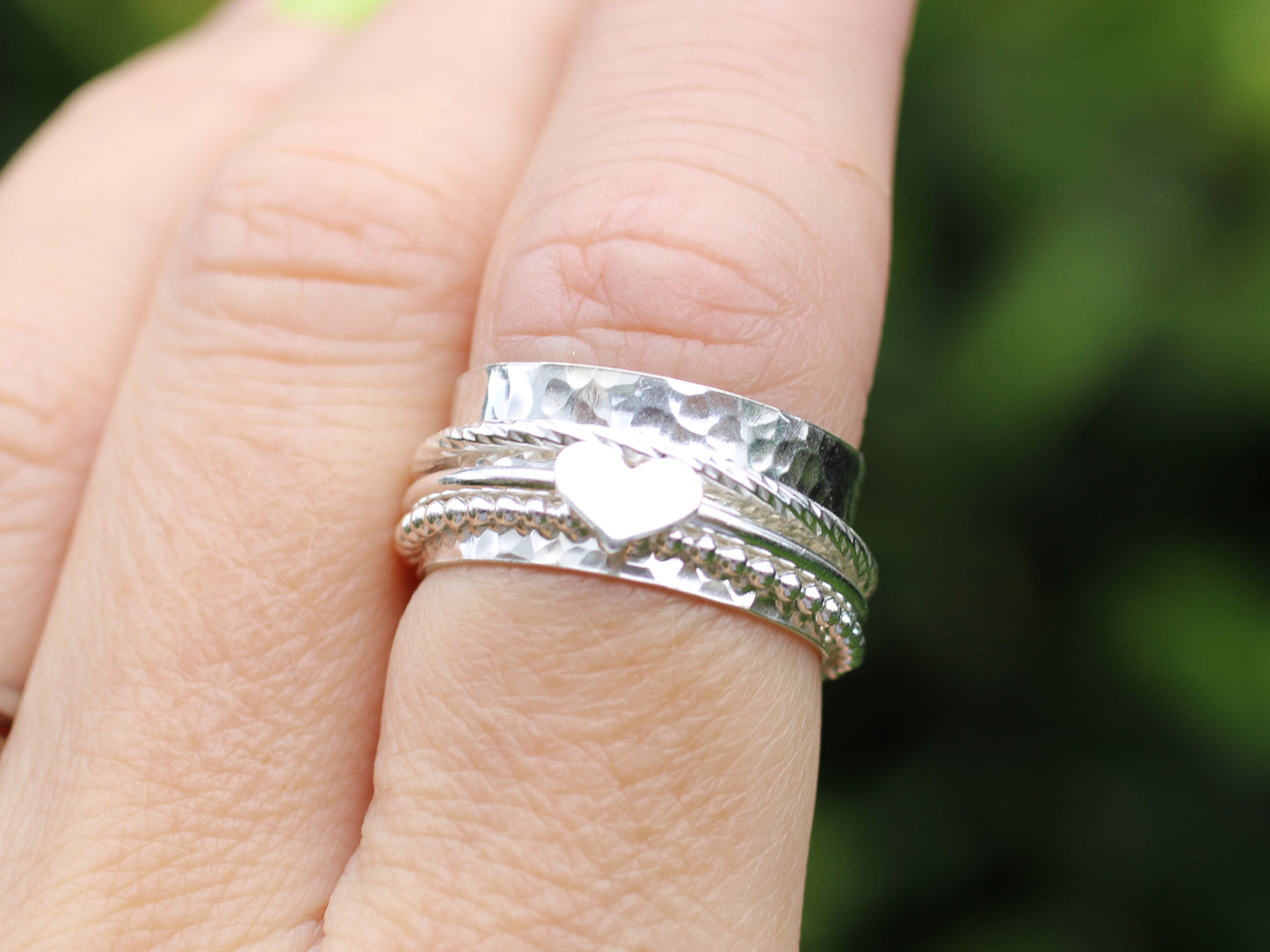 Sterling silver spinner ring with love heart charm.