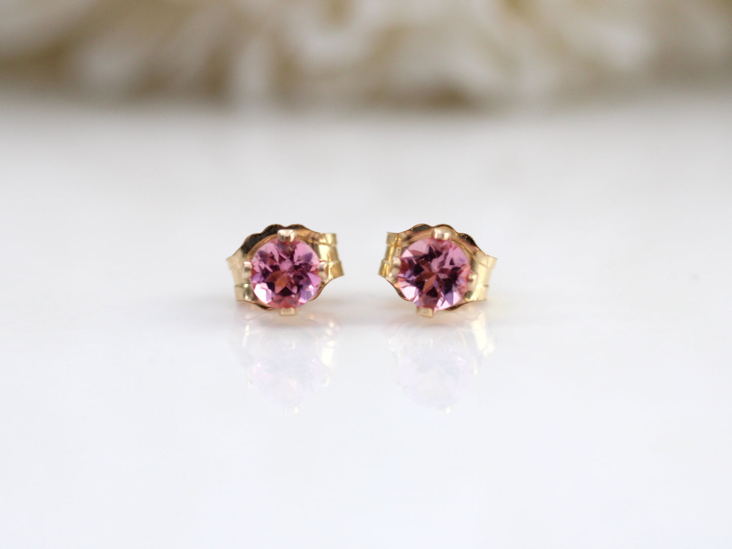 Pink tourmaline stud earrings in silver or gold.