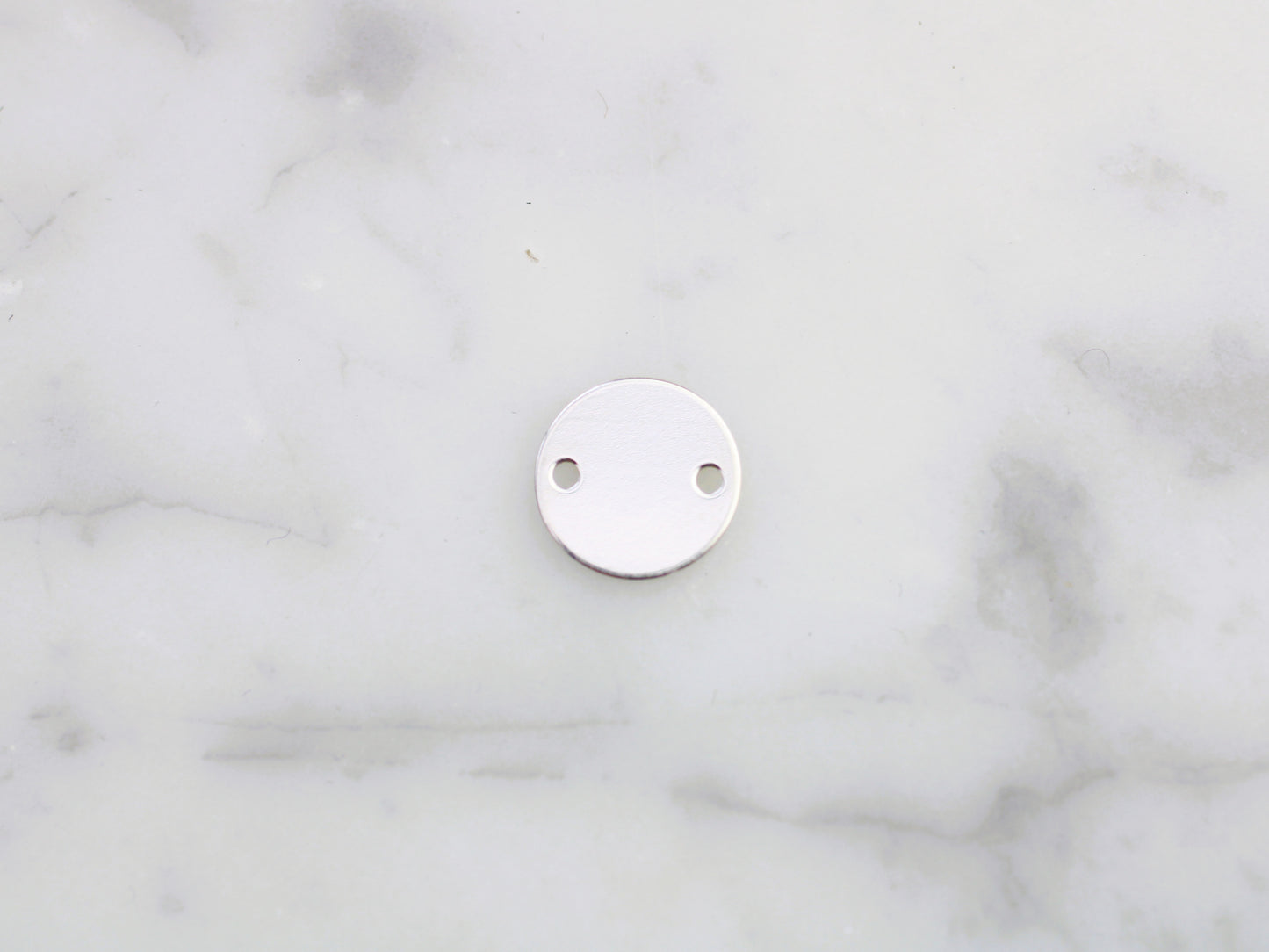 Personalised silver round connector.