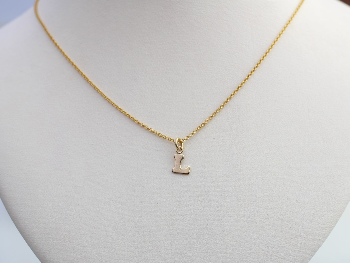 Dainty gold initial necklace.
