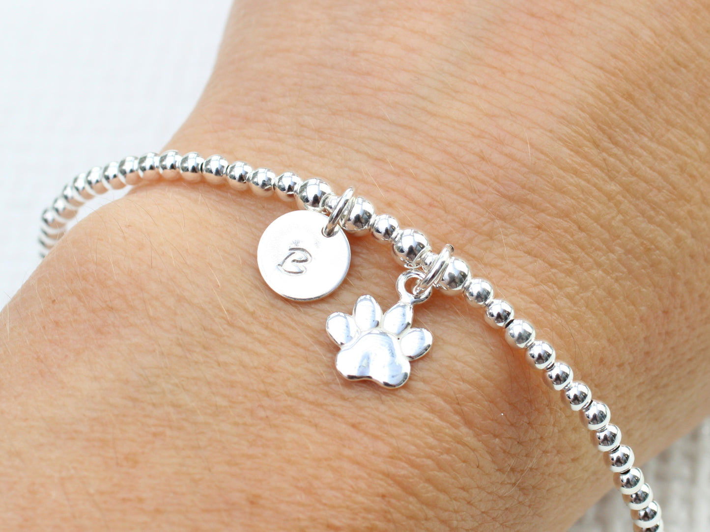 Paw print and initial charm bracelet.