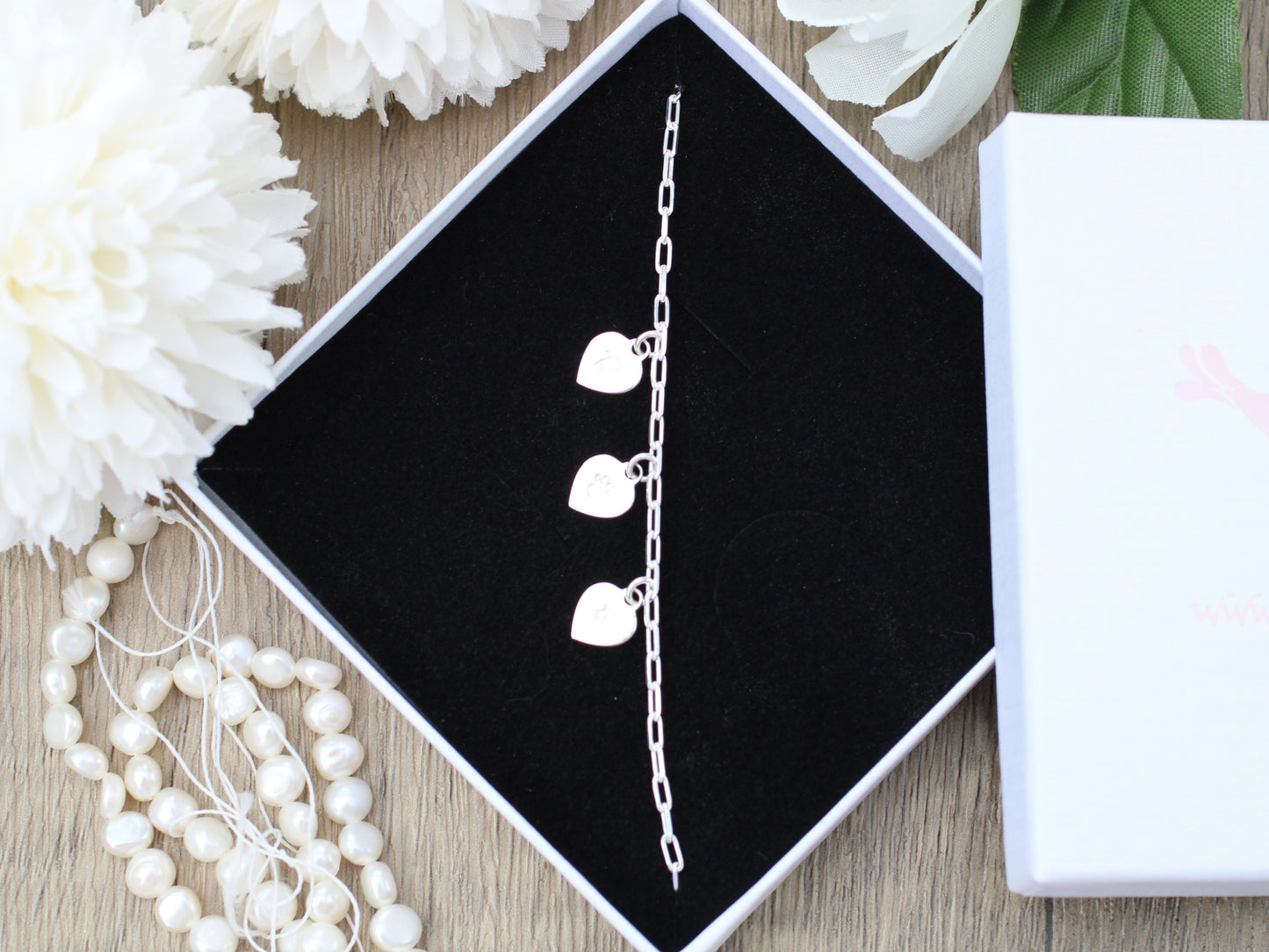 Personalised paw print and initial bracelet.