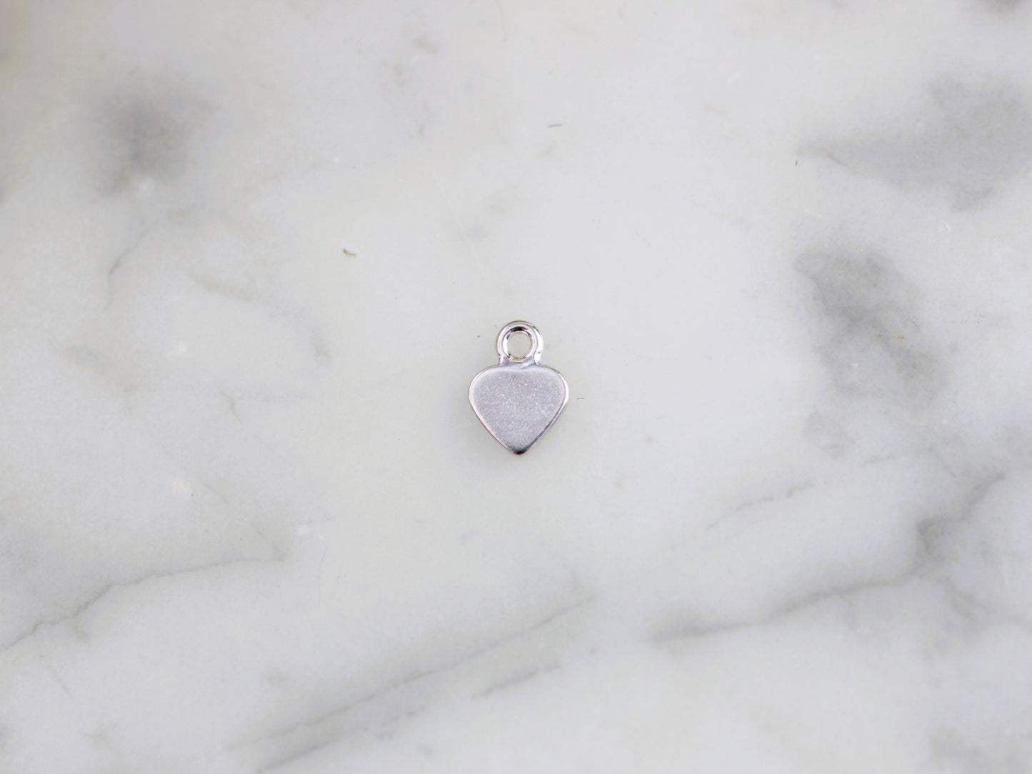 Tiny personalised heart charm.