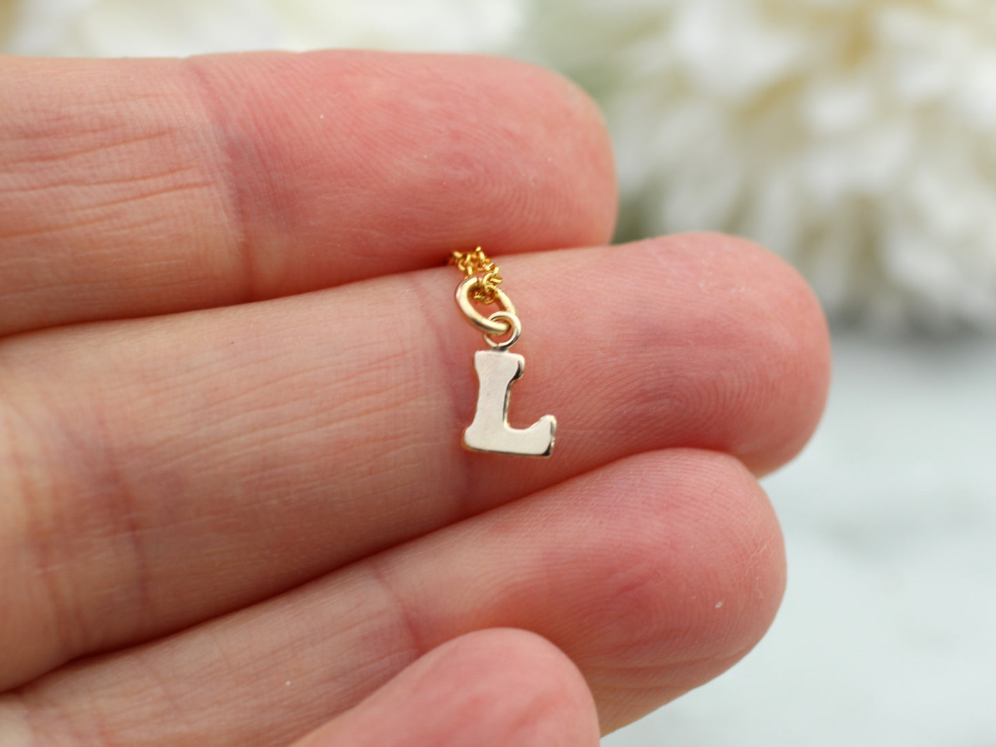 Dainty gold initial necklace.
