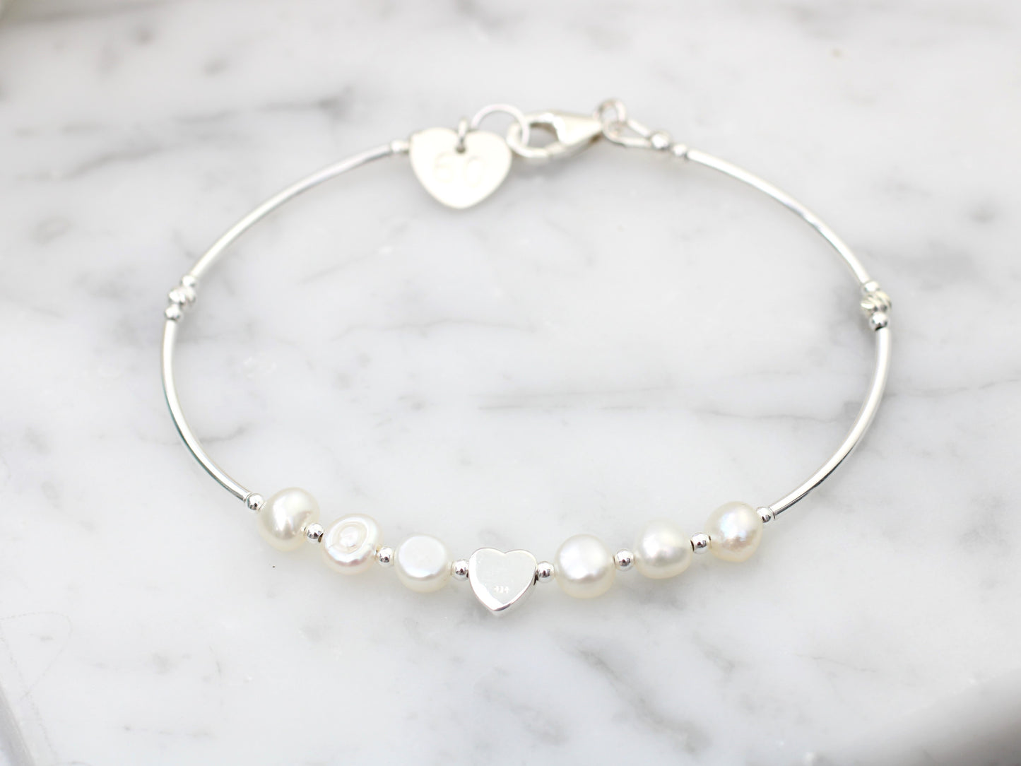 Personalised pearl bracelet in sterling silver.