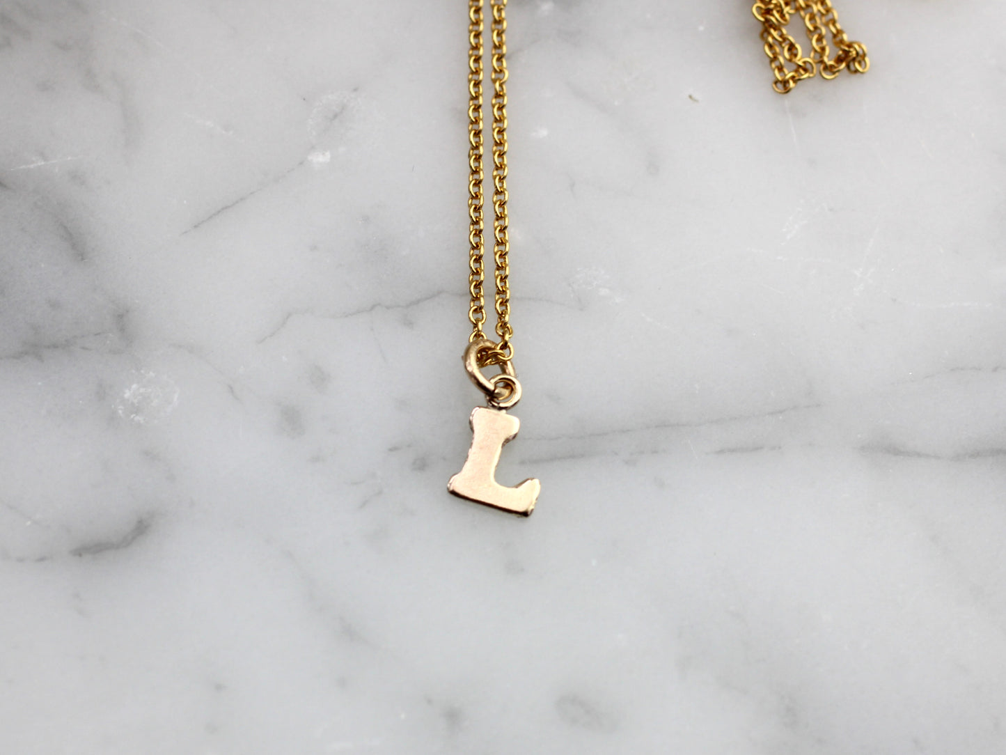 Dainty gold initial necklace.
