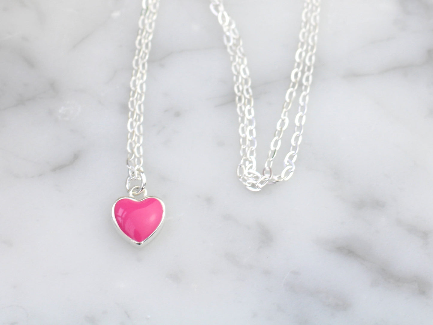 Pink heart charm necklace.