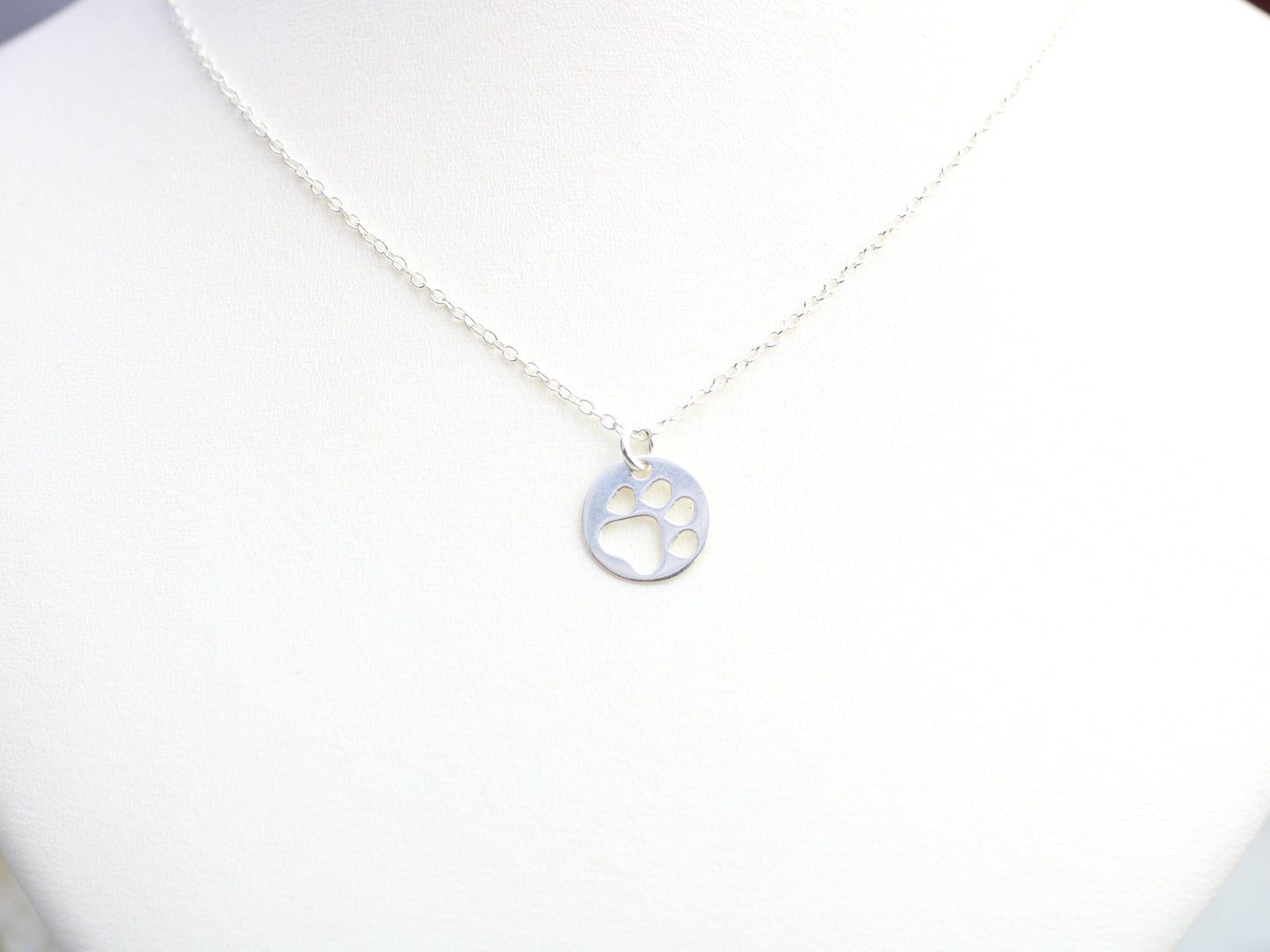 Silver paw print necklace.