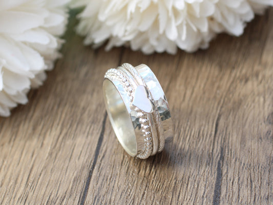 Sterling silver spinner ring with love heart charm.