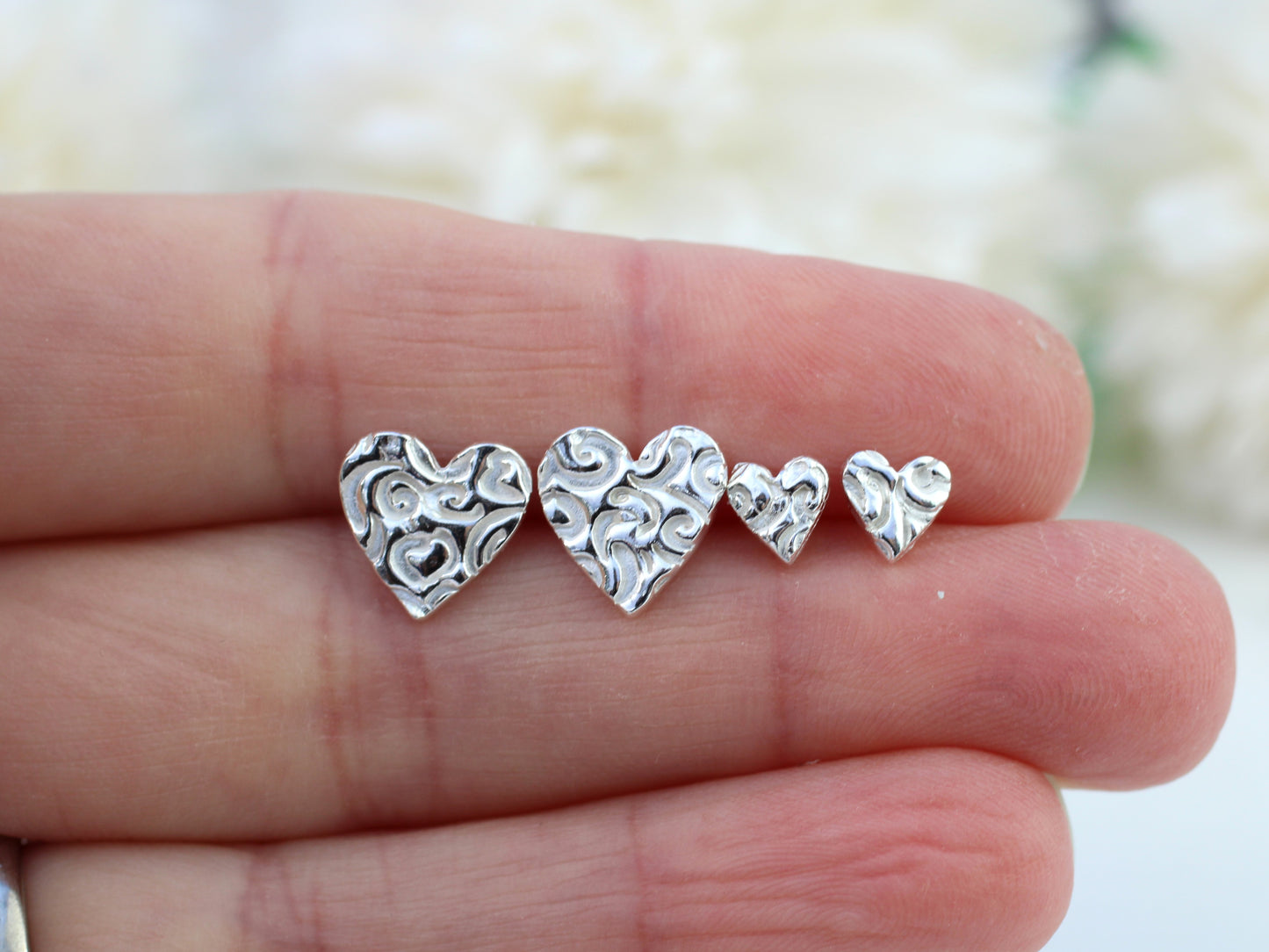 Pure silver heart stud earrings.
