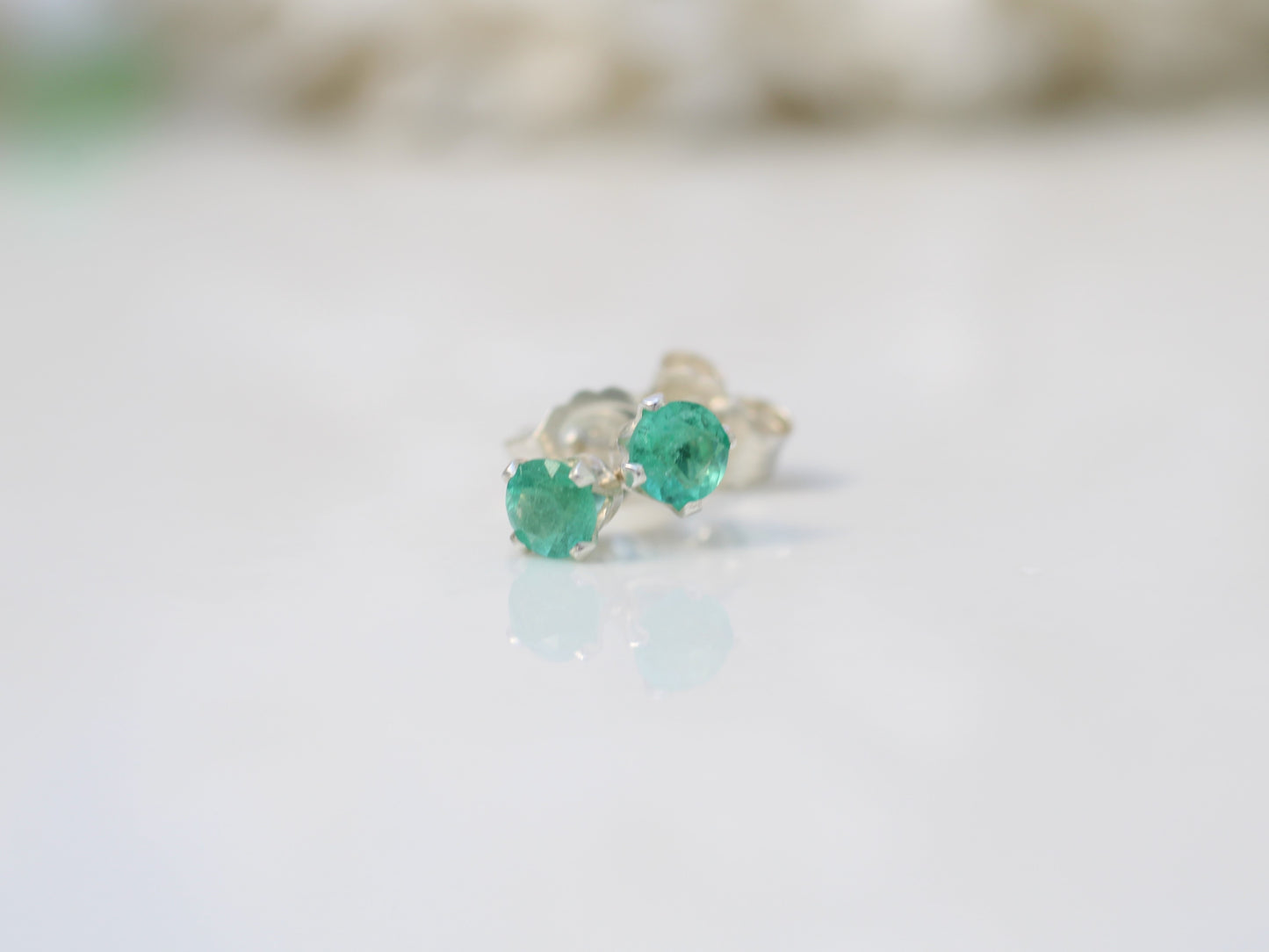 Genuine emerald stud earrings in silver or gold.