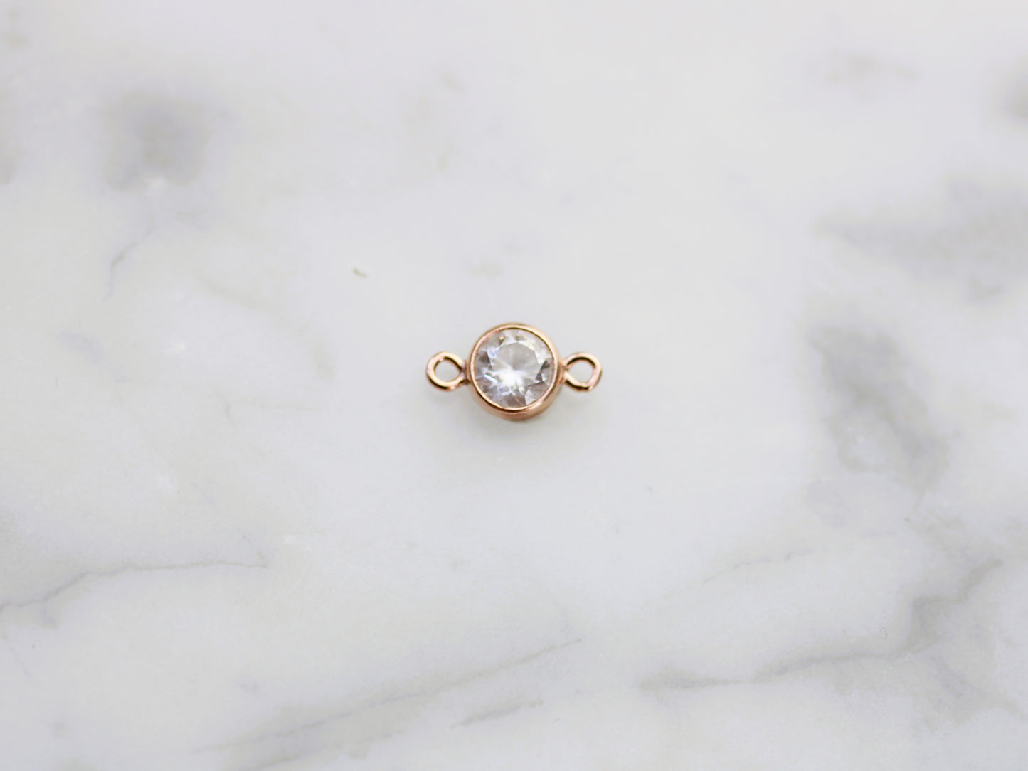 Rose gold crystal connector.