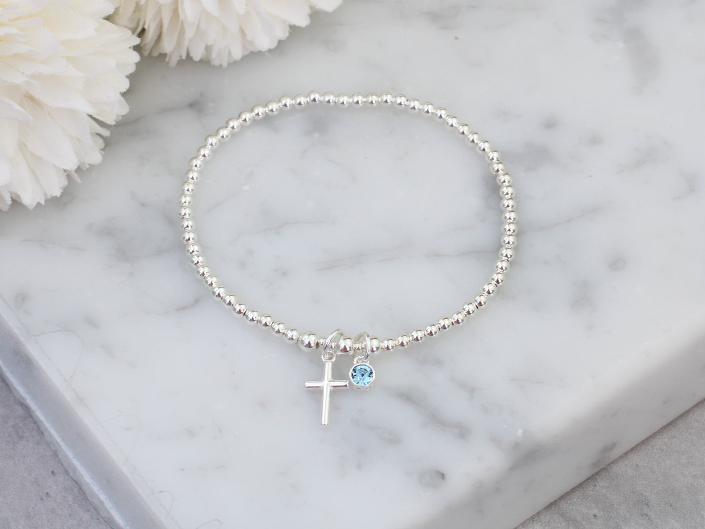 Cross bracelet with birthstone charm.