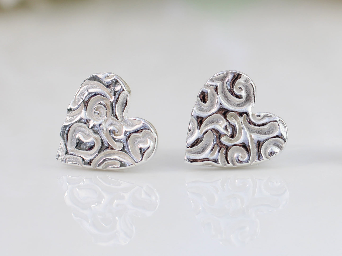 Pure silver heart stud earrings.