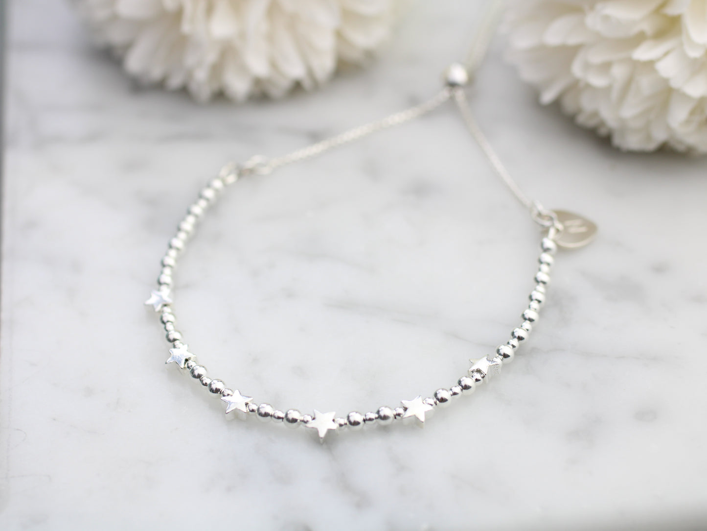 60th birthday bracelet. 60th birthday gift. Sterling silver star bracelet with slider clasp.