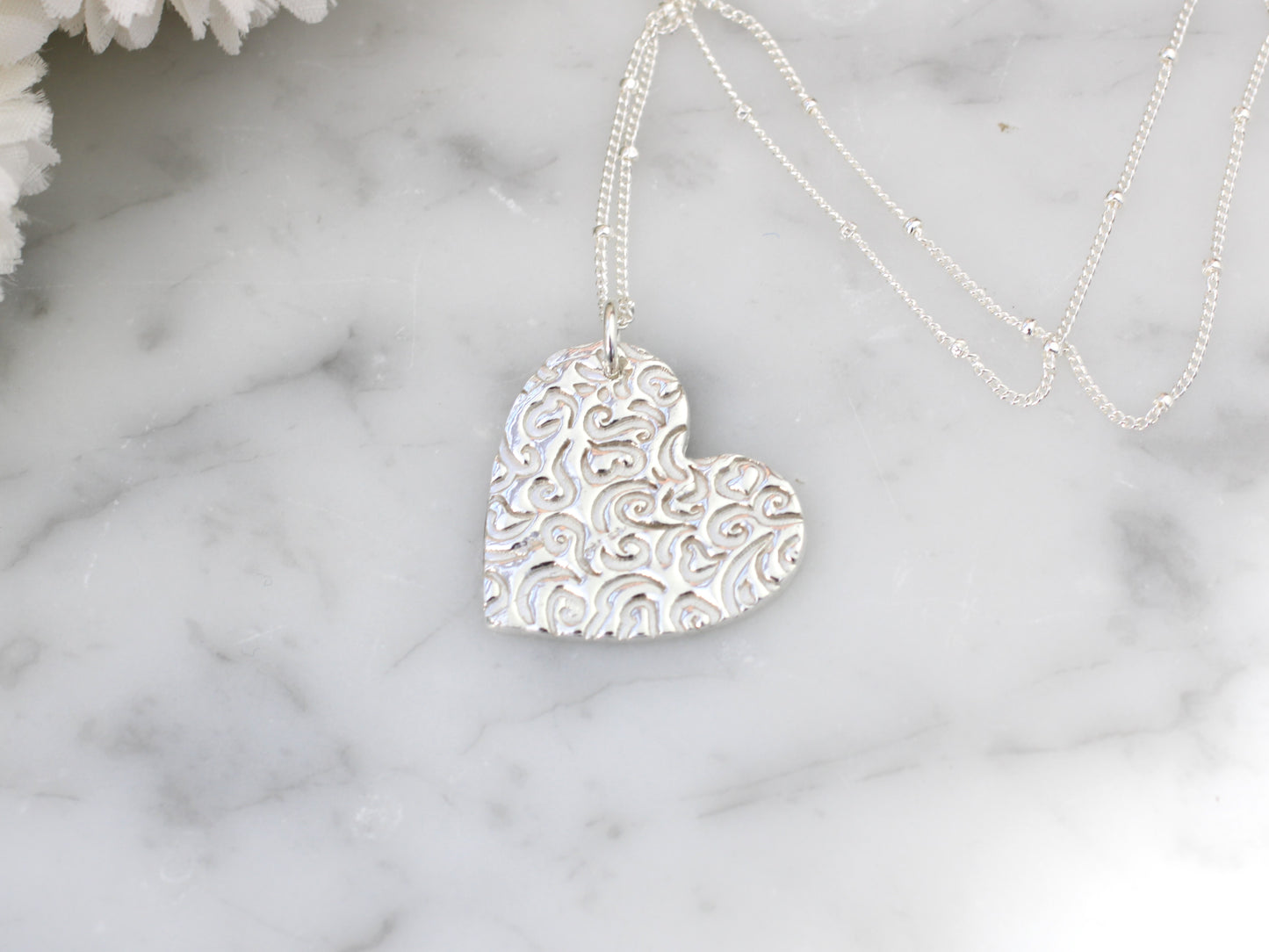 Pure silver heart pendant necklace.