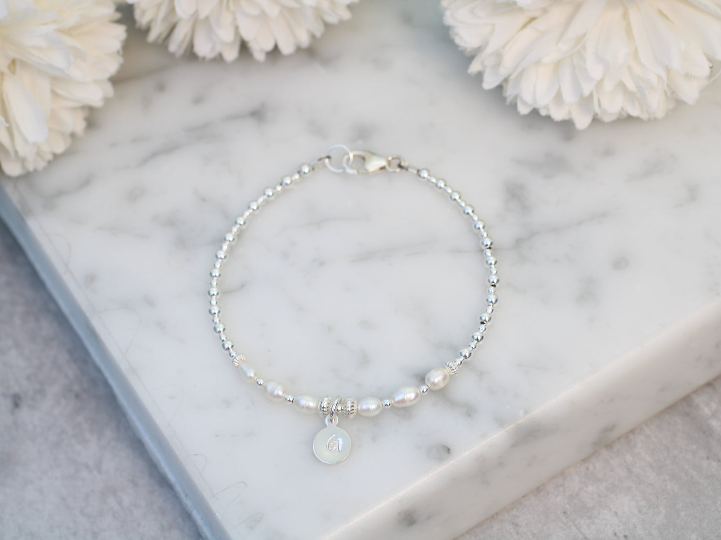 Freshwater pearl initial bracelet.