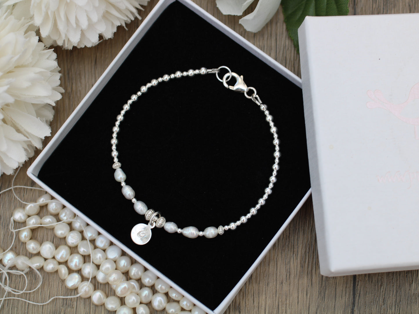 Freshwater pearl initial bracelet.