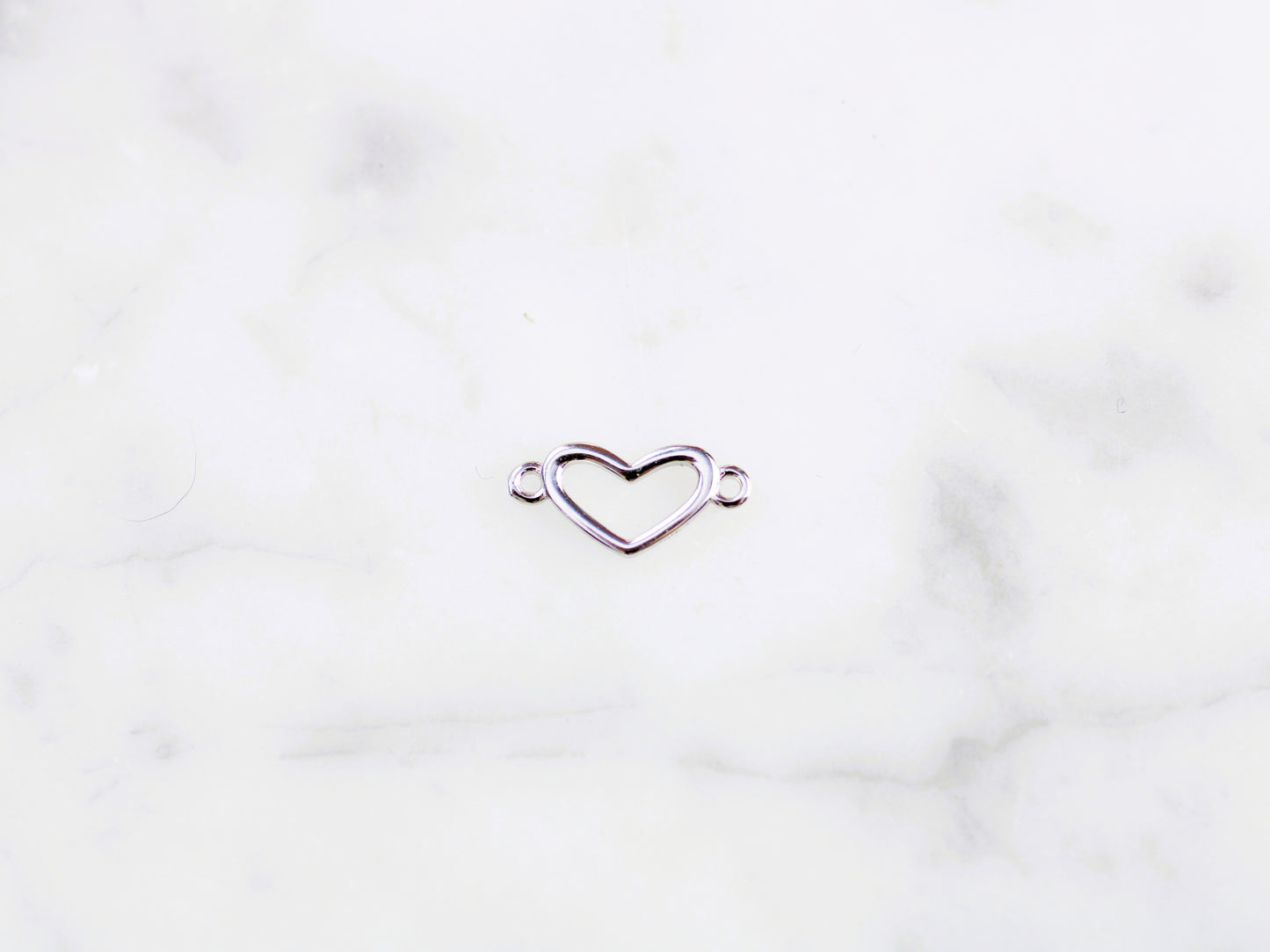 Heart connector in sterling silver.