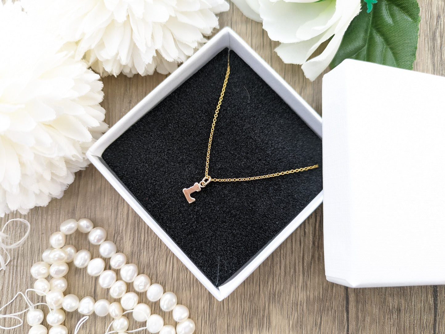 Dainty gold initial necklace.