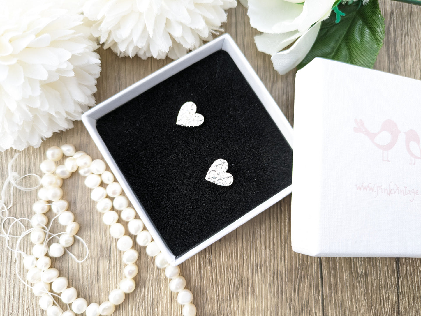 Pure silver heart stud earrings.