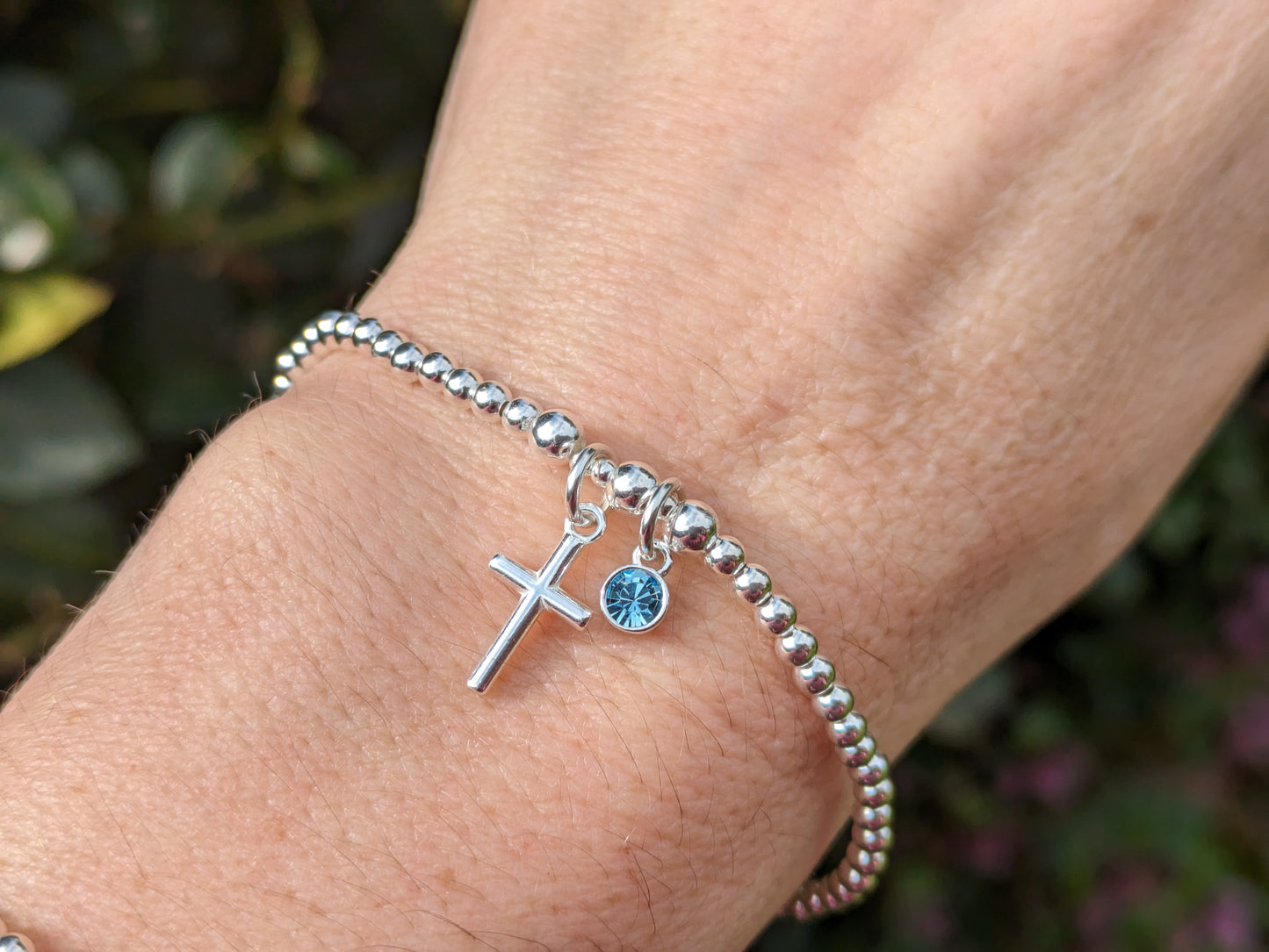 Cross bracelet with birthstone charm.