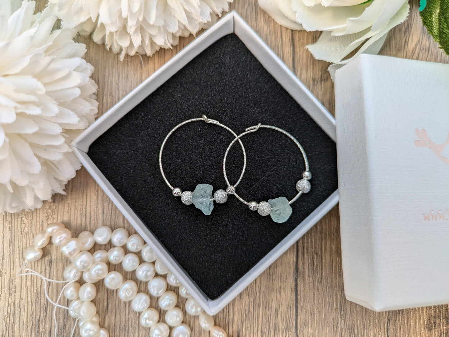 Raw aquamarine hoop earrings in sterling silver.
