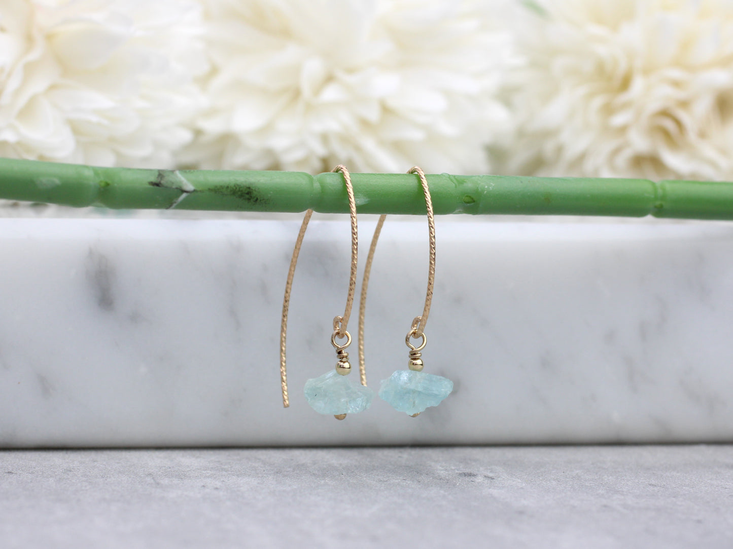 Raw aquamarine earrings in gold.