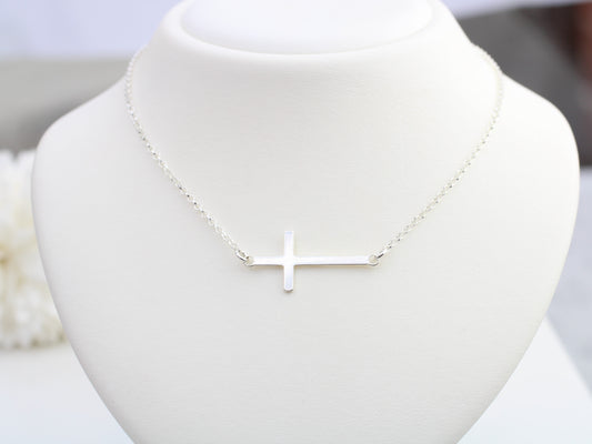 Sideways cross necklace. Confirmation present.