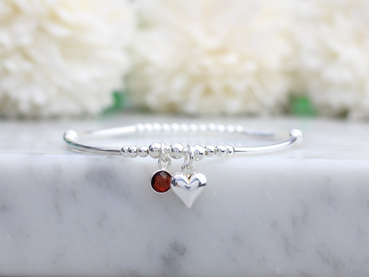 Sterling silver bead bracelet with garnet charm.
