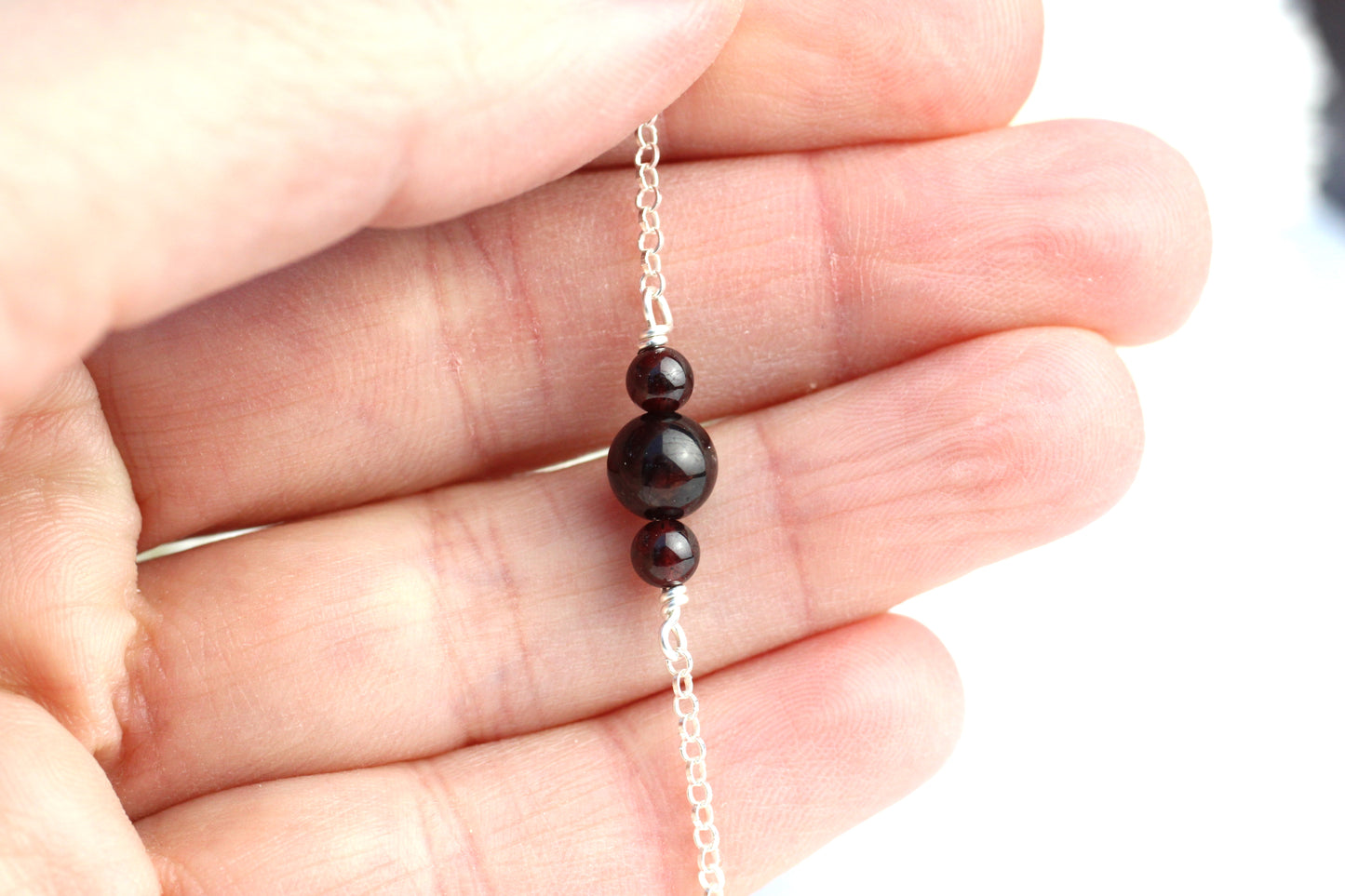 Garnet ankle bracelet in sterling silver.