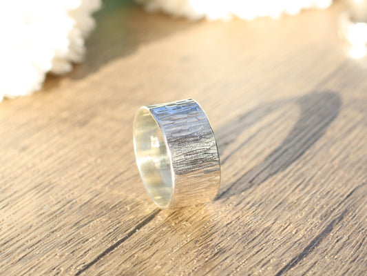 Sterling silver wood grain effect ring made with recycled metal.