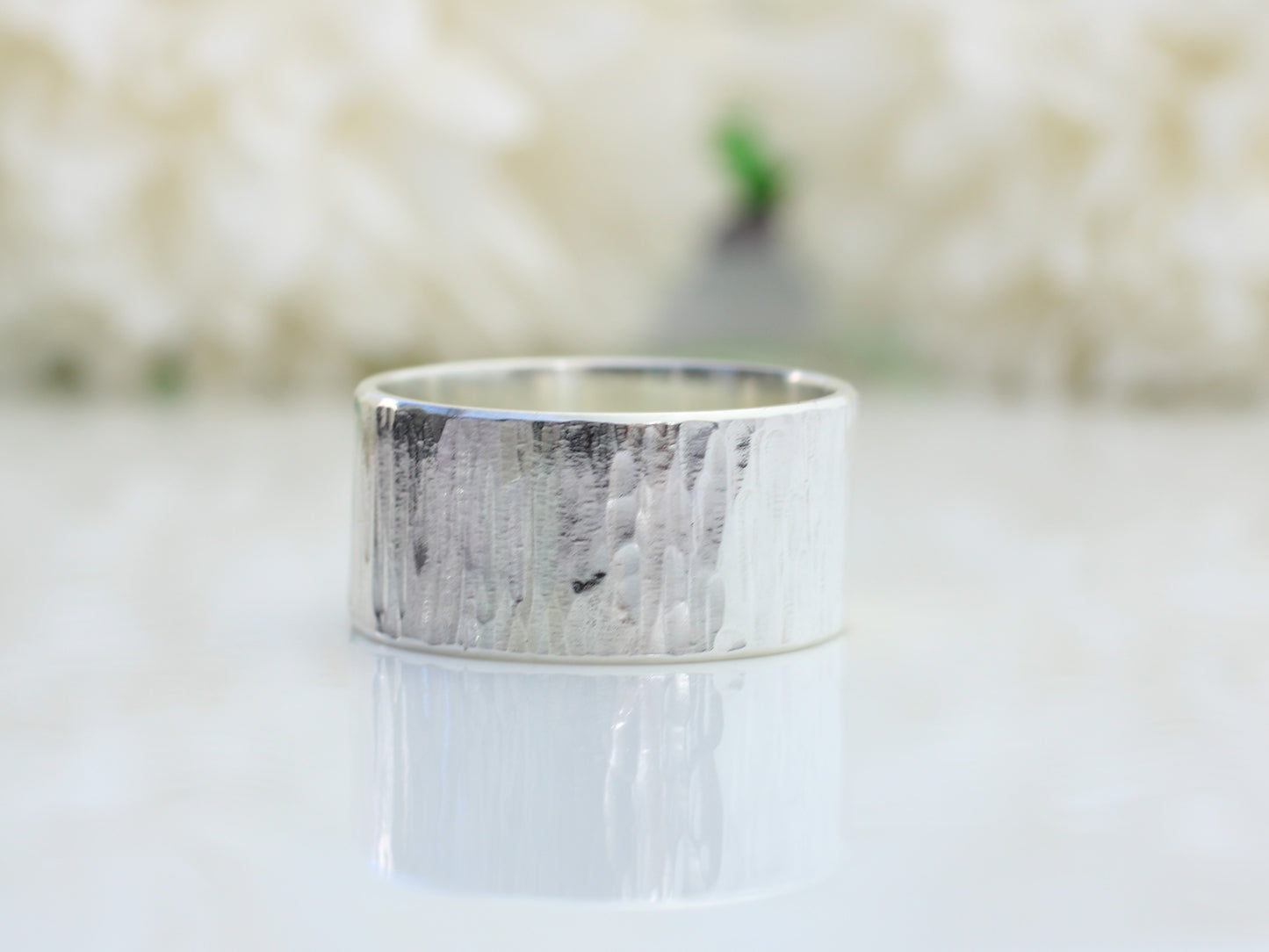 Sterling silver wood grain effect ring made with recycled metal.