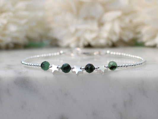 silver star bracelet with emerald gemstones