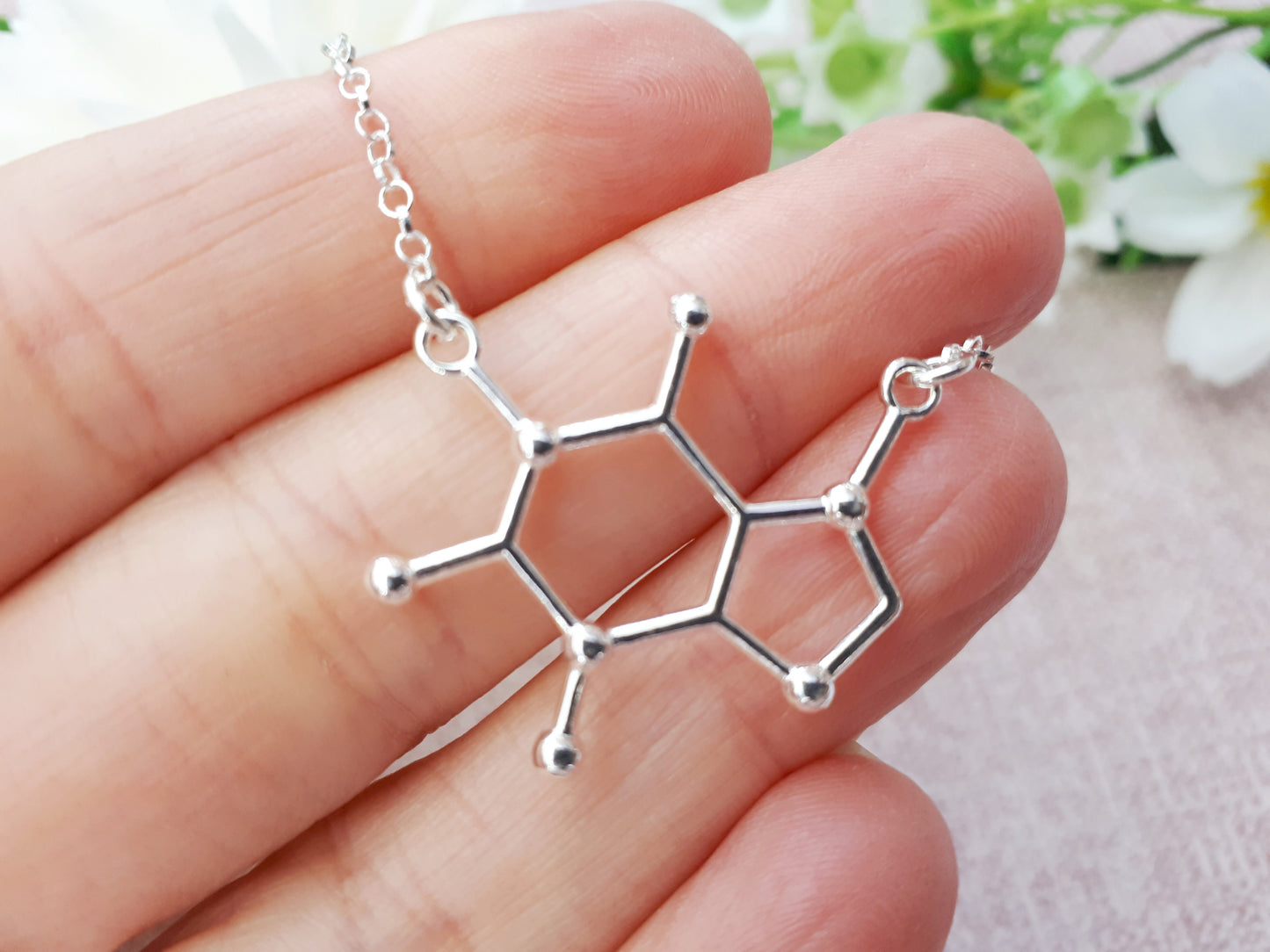 Caffeine molecule necklace.