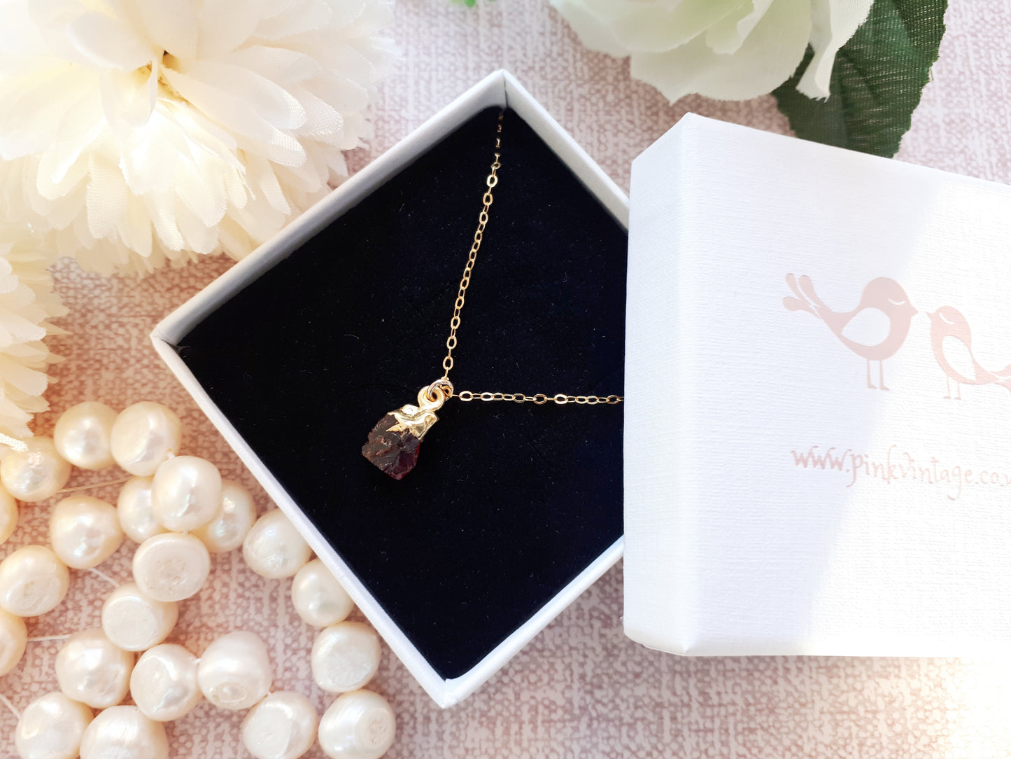Raw garnet necklace in gold.