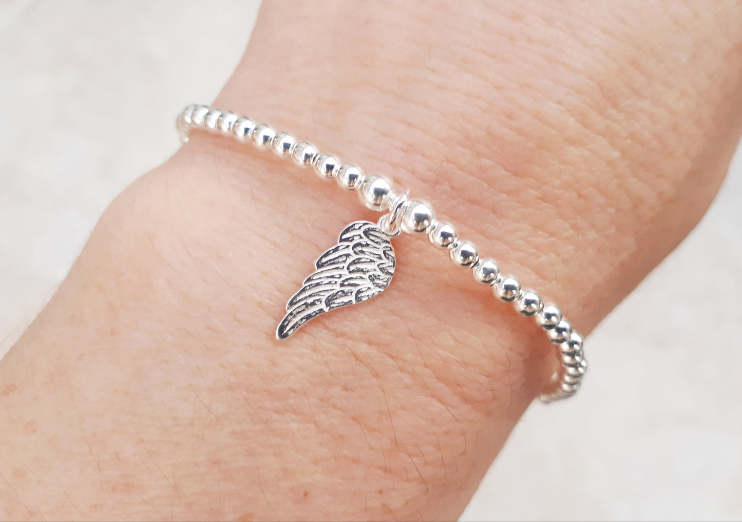 Sterling silver angel wing stretch bracelet.