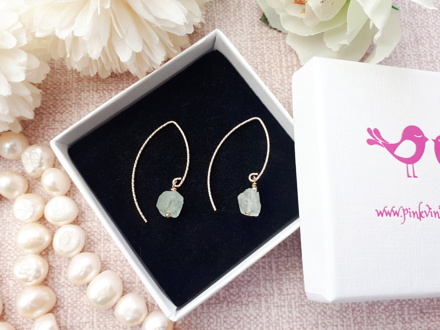 Raw aquamarine earrings in gold.