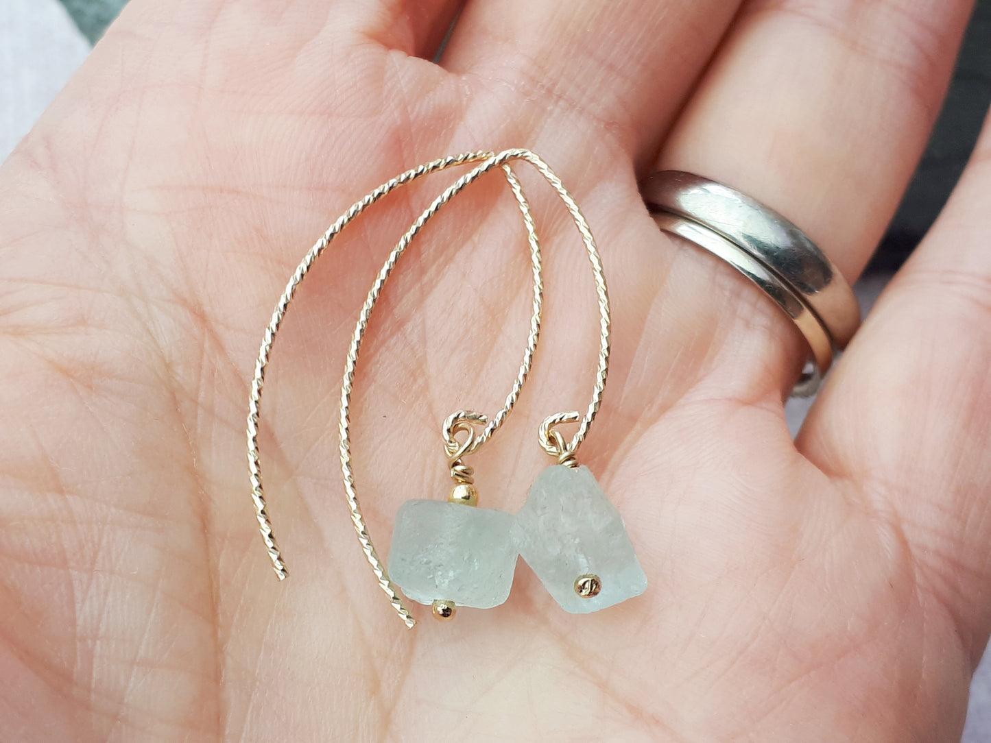 Raw aquamarine earrings in gold.