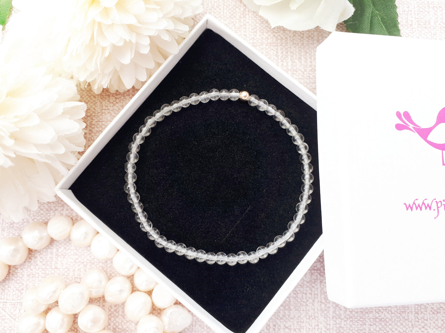 Quartz gemstone bracelet with gold accent bead.