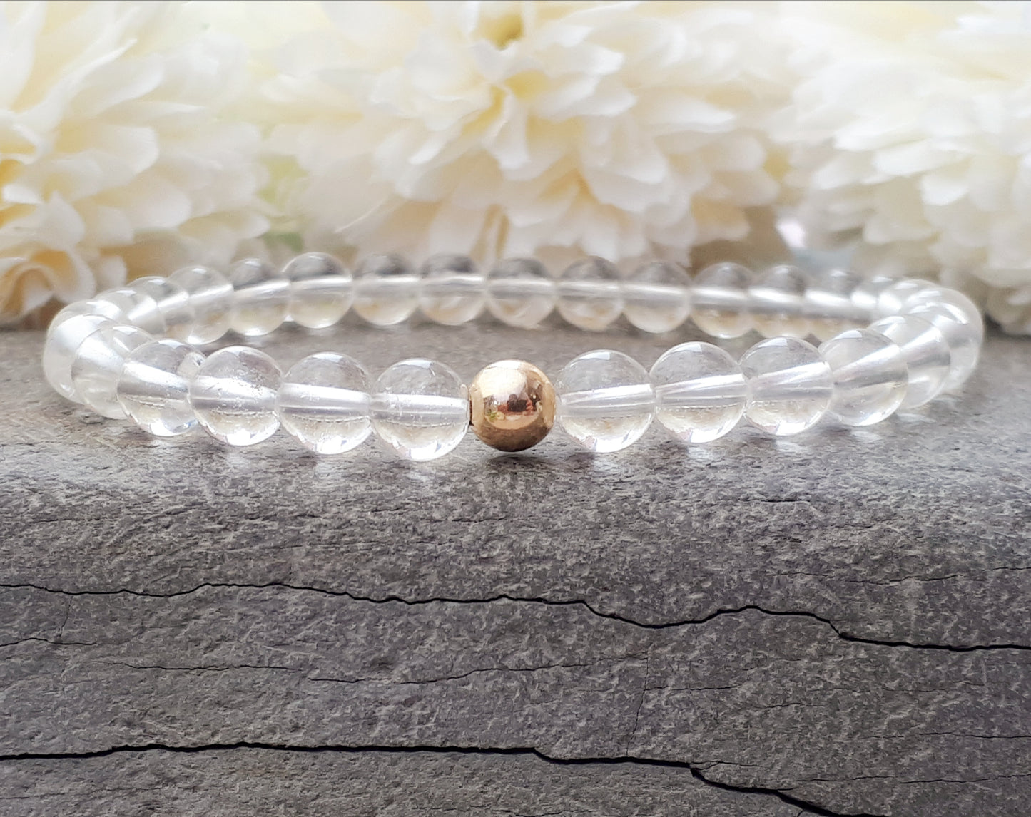 Quartz gemstone bracelet with gold accent bead.