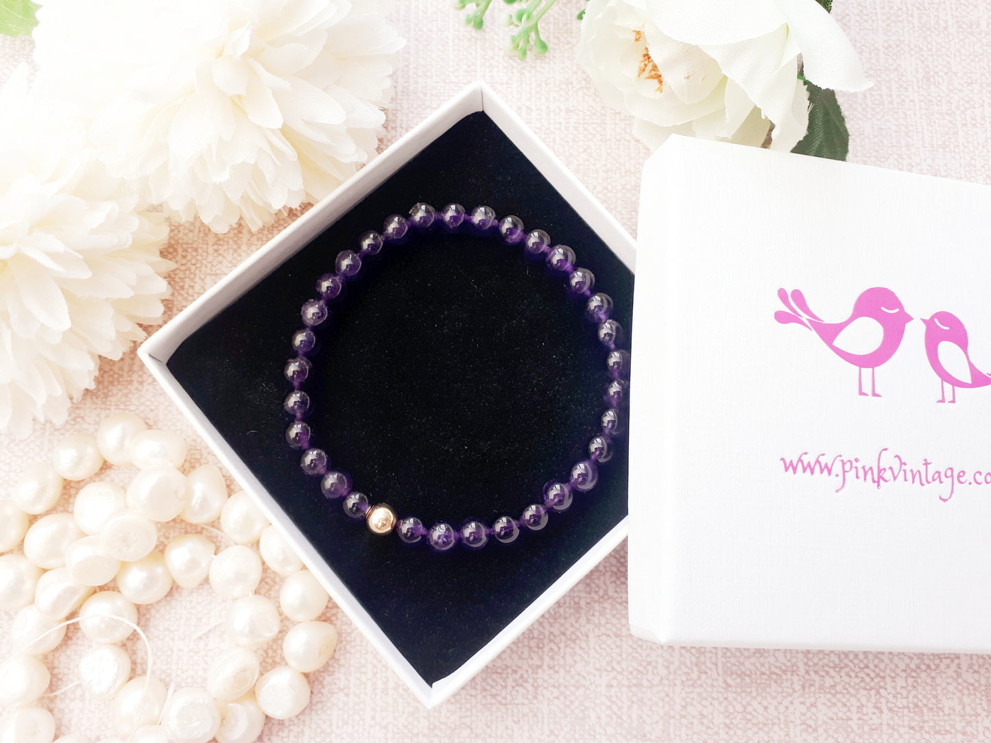 Amethyst bead bracelet with gold bead.