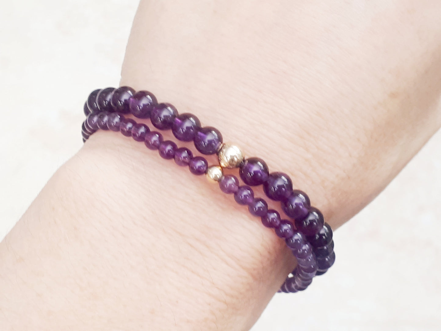 Amethyst bead bracelet with gold bead.