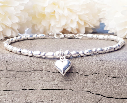 Sterling silver bead bracelet with love heart charm, can be personalised. Also available as a stretch bracelet.